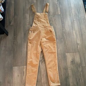 skinny-legged corduroy tan overalls